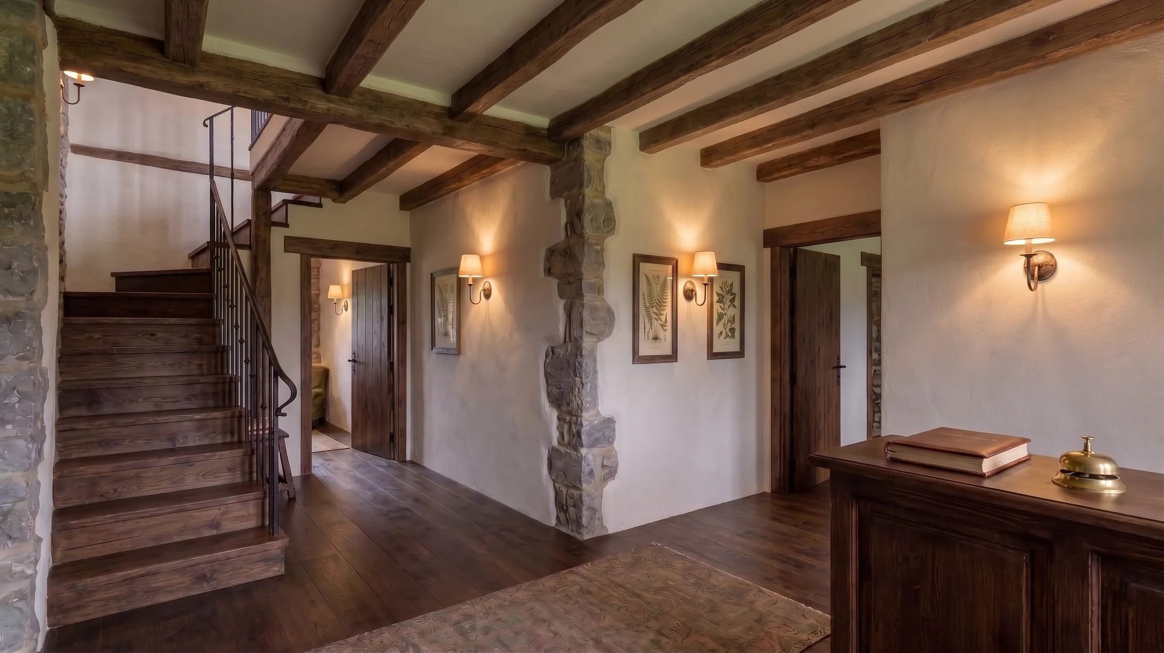 Recepción informal y escalera de madera y piedra en Casa Valdorna